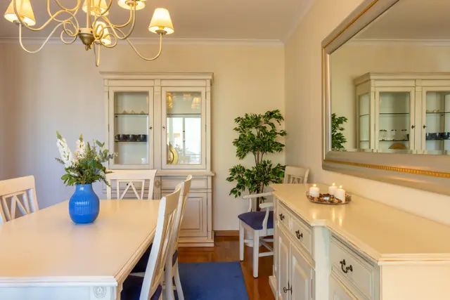 Dining corner with display cabinet, sideboard and mirror.