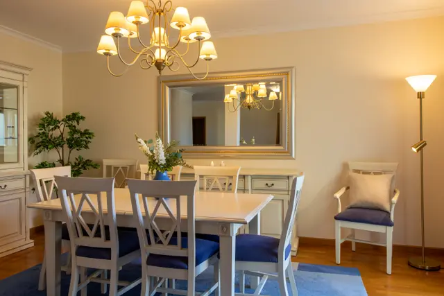 Dining table for six with mirror and sideboard.