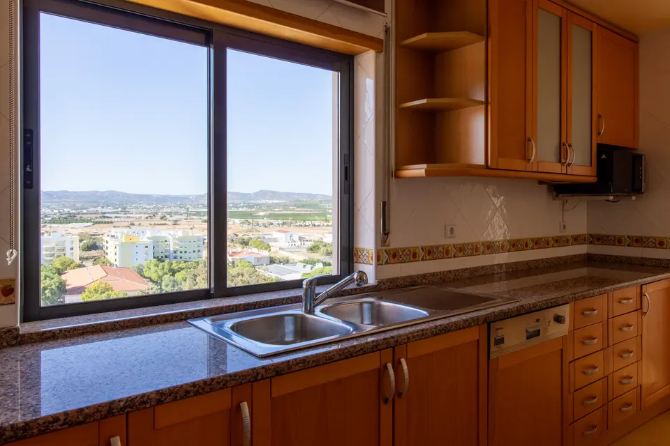Kitchen sink and worktop beside a window over the town.