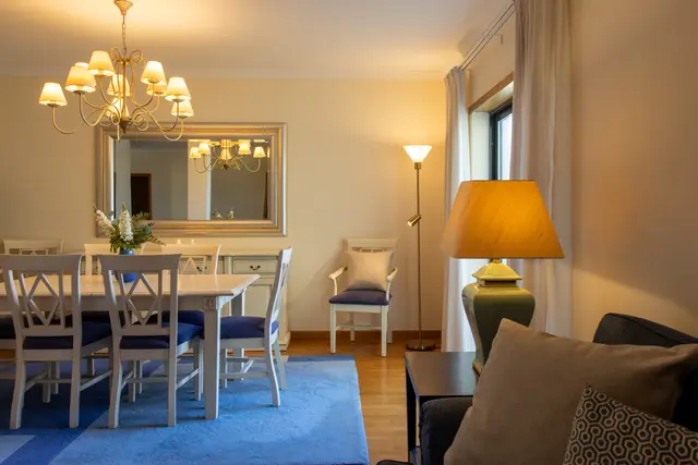 Shared lounge with sofa beside the dining table.