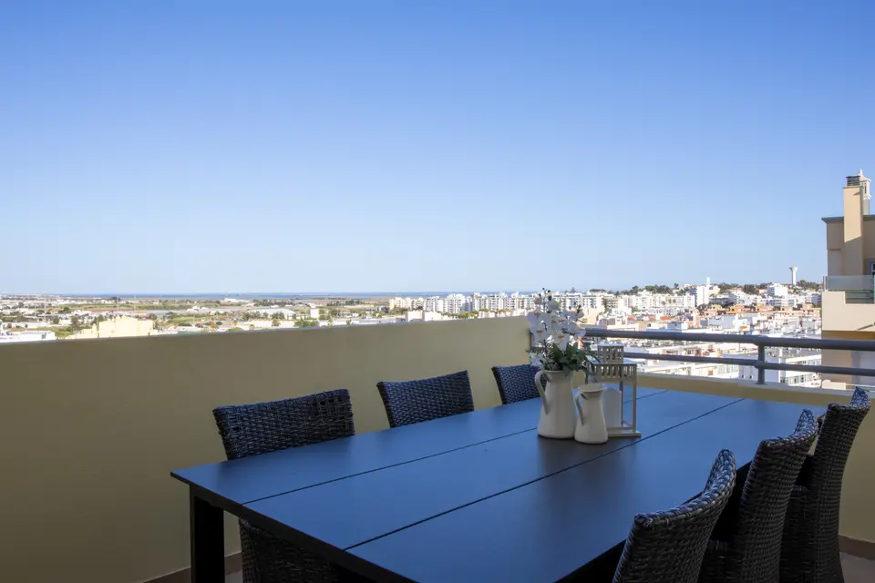 Rooftop terrace table with panoramic views to the sea.
