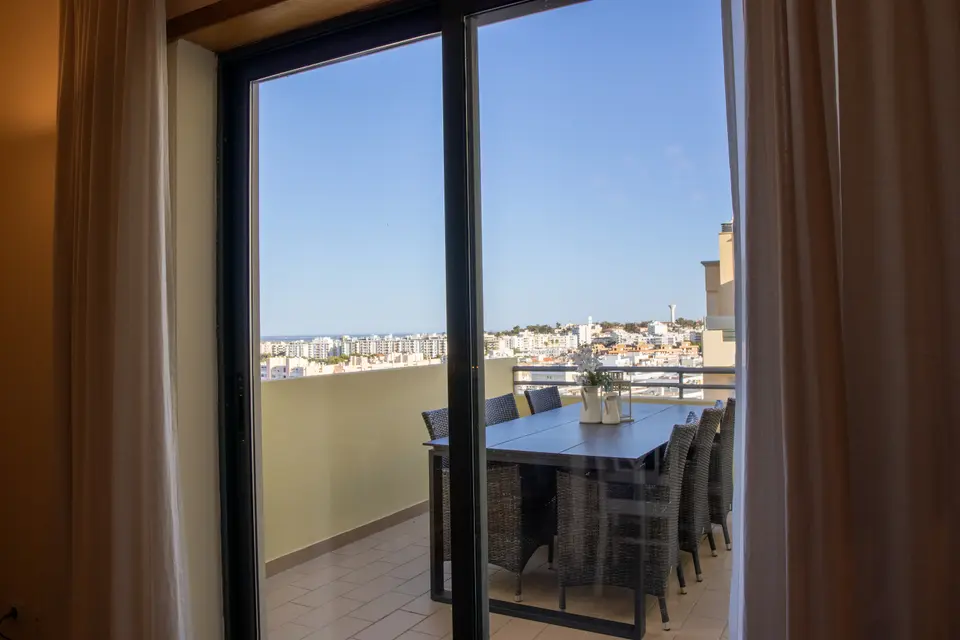 Terrace table seen through the sliding glass doors.